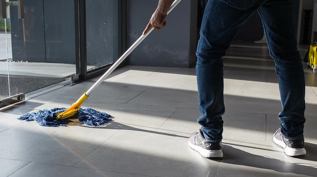 Man cleaning floor with mop