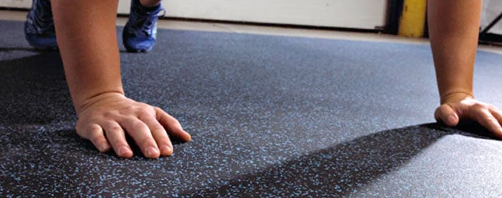 Man doing push ups on rolled rubber flooring from Zogics.